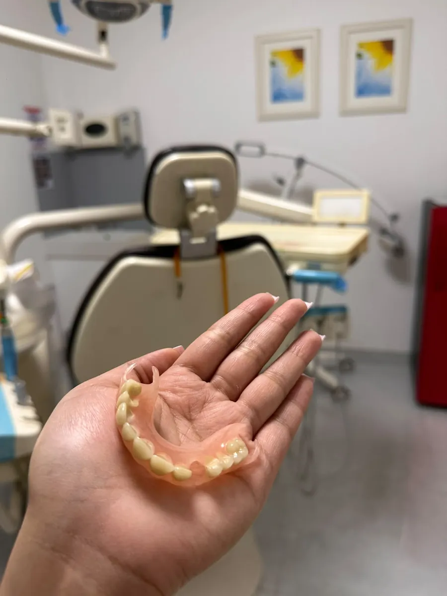 Denture held in a treatment room at Best Dentist in Al Rigga, Dubai
