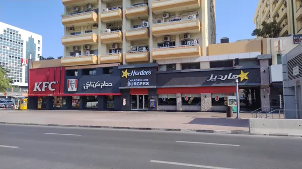 Best Dentist sign on the building above KFC and Hardee’s on Al Rigga Road, Dubai