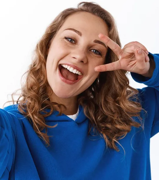 Smiling woman making a peace sign