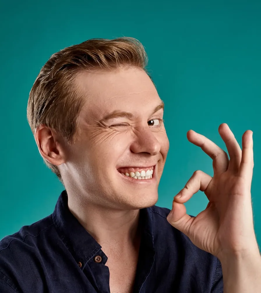 Smiling man winking and making an OK sign